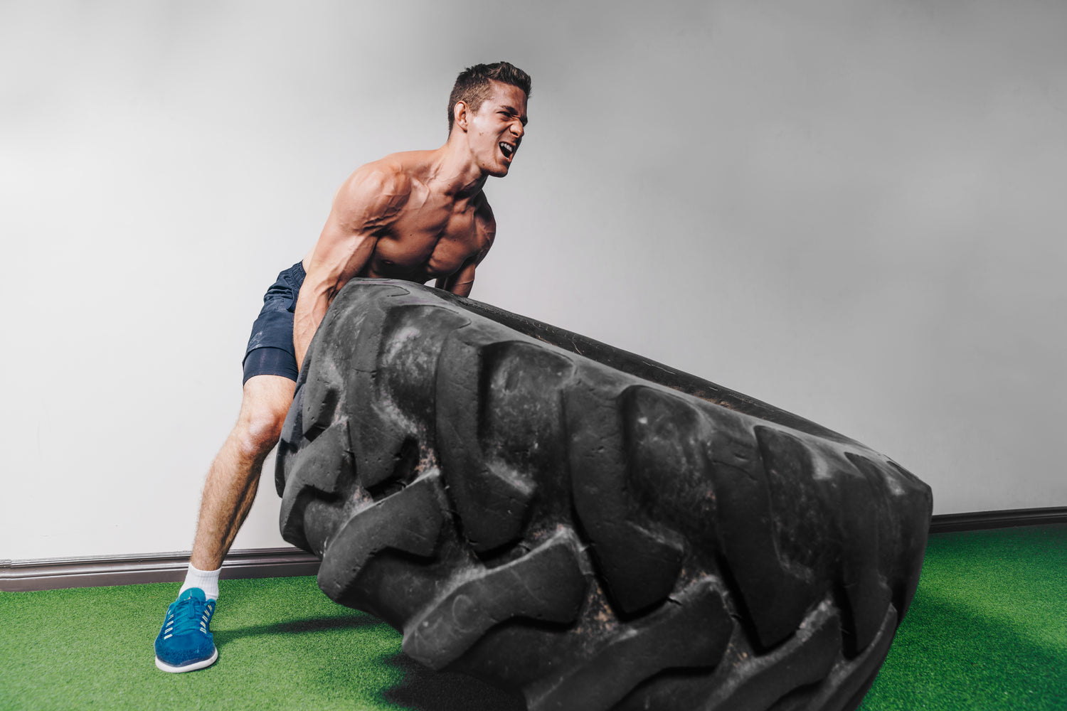 Man lifting a tire from The Wormanator's online fitness coaching Beta plan